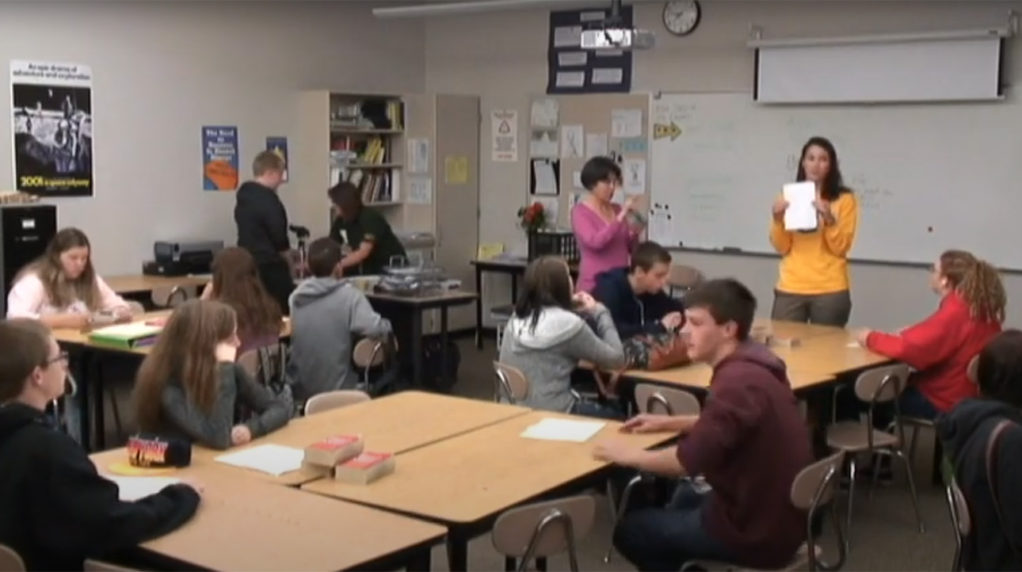 A classroom full of student with two teachers facilitating the activities.