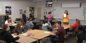 A classroom full of student with two teachers facilitating the activities.